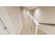Upstairs hallway featuring neutral carpet and white railing at 3930 Willow Gate Way, Raleigh, NC 27604