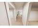 Bright hallway featuring neutral carpet, white trim and doors leading to rooms with closet space at 3930 Willow Gate Way, Raleigh, NC 27604