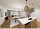 Open-concept living and dining area with hardwood floors, contemporary furnishings, and plenty of natural light at 3930 Willow Gate Way, Raleigh, NC 27604