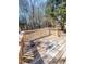 Wooden back deck overlooking a spacious yard with plenty of surrounding trees at 4204 Labrador Dr, Raleigh, NC 27616