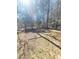Spacious backyard with lush, surrounding trees and a wooden storage shed at 4204 Labrador Dr, Raleigh, NC 27616