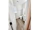 Bathroom featuring wood-look floors, white vanity, and a toilet with shelving above at 4204 Labrador Dr, Raleigh, NC 27616