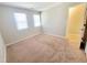 Bright bedroom with carpeting, two windows, and neutral colors at 4204 Labrador Dr, Raleigh, NC 27616