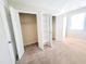A spacious bedroom featuring plush carpeting and ample closet space with shelving for optimal organization at 4204 Labrador Dr, Raleigh, NC 27616