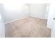 Bright bedroom with neutral carpet, light walls, and a closed white door at 4204 Labrador Dr, Raleigh, NC 27616
