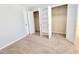 Bright bedroom featuring neutral carpet, light walls, open closet, and white doors at 4204 Labrador Dr, Raleigh, NC 27616