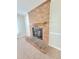Close-up view of a classic brick fireplace with wooden mantel, providing warmth and charm to the living space at 4204 Labrador Dr, Raleigh, NC 27616