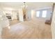 Open-concept living space with modern kitchen appliances, easy access to stairs, and a brick fireplace at 4204 Labrador Dr, Raleigh, NC 27616