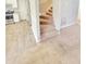 Carpeted staircase leading to the upper level with a view of the kitchen area at 4204 Labrador Dr, Raleigh, NC 27616