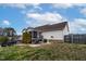 Back of the home featuring a screened-in porch and ample backyard space with mature trees and a privacy fence at 47 London Ln, Angier, NC 27501