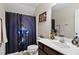 Bathroom with a large shower curtain with blue accents and a vanity with storage at 47 London Ln, Angier, NC 27501