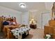 Cozy bedroom featuring a bed with a rustic wooden frame and a dresser with a lamp at 47 London Ln, Angier, NC 27501