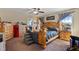 Primary bedroom features soft natural light and ample furnishings with ensuite bathroom at 47 London Ln, Angier, NC 27501
