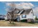 Well-maintained home featuring a cozy front porch, black shutters, and mature landscaping in a Gathering-friendly neighborhood at 47 London Ln, Angier, NC 27501