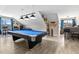 Bright game room boasts a blue pool table, wood floors, and a bar area for entertainment at 47 London Ln, Angier, NC 27501