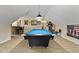 Open game room provides a bright blue pool table, bar, and ample space for social gatherings at 47 London Ln, Angier, NC 27501