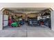 Spacious two-car garage equipped with storage shelves, a lawn mower, and a parked vehicle at 47 London Ln, Angier, NC 27501