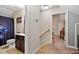 Hallway featuring an open doorway and staircase, and a bathroom with an interesting shower curtain at 47 London Ln, Angier, NC 27501
