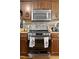 Modern kitchen with stainless steel appliances, including a microwave and oven at 47 London Ln, Angier, NC 27501