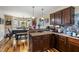 Open-concept kitchen with dark wood cabinets and flooring adjacent to breakfast nook at 47 London Ln, Angier, NC 27501