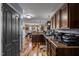Open-concept kitchen with dark cabinets and hardwood floors at 47 London Ln, Angier, NC 27501