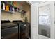 Convenient laundry room with machines, shelving, and unique glass door at 47 London Ln, Angier, NC 27501