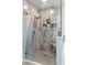 Modern shower featuring stone-look surround, stylish fixtures, built-in niches, and frameless glass enclosure at 47 London Ln, Angier, NC 27501