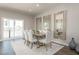 Elegant dining room with a wooden table, six chairs, large mirrors, and a sliding glass door at 500 Trilith Pl, Durham, NC 27713