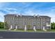 Gray townhomes offer modern charm with symmetrical windows, black roof lines, and landscaped front yards at 500 Trilith Pl, Durham, NC 27713
