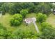 Aerial view of the property showing the house with a large front and back yard and mature trees at 524 N Occoneechee St, Hillsborough, NC 27278