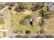 Aerial view of a property featuring a well-maintained lawn and tree coverage, offering tranquility and privacy at 524 N Occoneechee St, Hillsborough, NC 27278