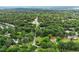 An aerial view of the home surrounded by lush trees in a picturesque neighborhood at 524 N Occoneechee St, Hillsborough, NC 27278