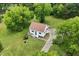 An aerial view of the home showcasing the large, grassy yard and a long driveway at 524 N Occoneechee St, Hillsborough, NC 27278