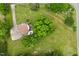 An aerial view of the home showcasing its location on the lot with a deck and surrounding trees at 524 N Occoneechee St, Hillsborough, NC 27278