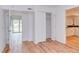 Open bedroom with wood floors, sliding glass doors, closet and access to kitchen at 524 N Occoneechee St, Hillsborough, NC 27278