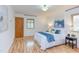 Comfortable bedroom with wood floors featuring a queen-sized bed and large windows at 524 N Occoneechee St, Hillsborough, NC 27278
