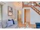 Comfortable living room with open hallway, hardwood floors, soft colored sofa and staircase at 524 N Occoneechee St, Hillsborough, NC 27278