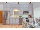 Modern kitchen with stainless steel appliances, gray cabinets, and wood floors for a sleek and stylish cooking space at 524 N Occoneechee St, Hillsborough, NC 27278