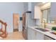 Bright kitchen with stainless steel appliances, custom cabinetry, and hardwood floors, offering modern appeal at 524 N Occoneechee St, Hillsborough, NC 27278
