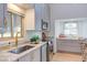 A modern kitchen with stainless appliances, stone countertops, and ample natural light at 524 N Occoneechee St, Hillsborough, NC 27278