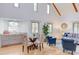 Bright living room features high ceilings, exposed beams, and cozy seating area with a dining table at 524 N Occoneechee St, Hillsborough, NC 27278