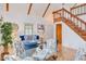 Inviting living room with hardwood floors, wood beams, and a staircase to the upper level at 524 N Occoneechee St, Hillsborough, NC 27278