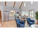 Open-concept living room featuring a modern kitchen, hardwood floors, and vaulted ceilings for a light, spacious feel at 524 N Occoneechee St, Hillsborough, NC 27278