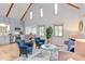 This inviting living room has an open layout, vaulted ceilings, and exposed wood beams for a charming aesthetic at 524 N Occoneechee St, Hillsborough, NC 27278