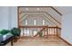 A loft area with wooden floors, railing, and high ceilings at 524 N Occoneechee St, Hillsborough, NC 27278