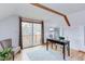 This home office features natural light, desk, chair, and sliding doors to the balcony at 524 N Occoneechee St, Hillsborough, NC 27278
