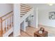 Bright foyer with a white staircase, wood floors, and natural light at 524 N Occoneechee St, Hillsborough, NC 27278