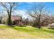 A big yard with a home in the distance with a nice wooden deck and tree at 524 N Occoneechee St, Hillsborough, NC 27278