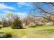 A big yard with a home in the distance surrounded by trees at 524 N Occoneechee St, Hillsborough, NC 27278