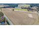 Wide aerial shot showcasing a large land tract with open fields and natural features at 525 Sanctuary Trl, Cameron, NC 28326